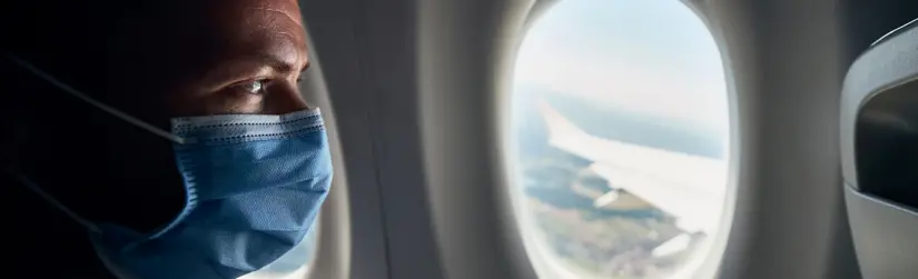 Man on airplane looking out the window